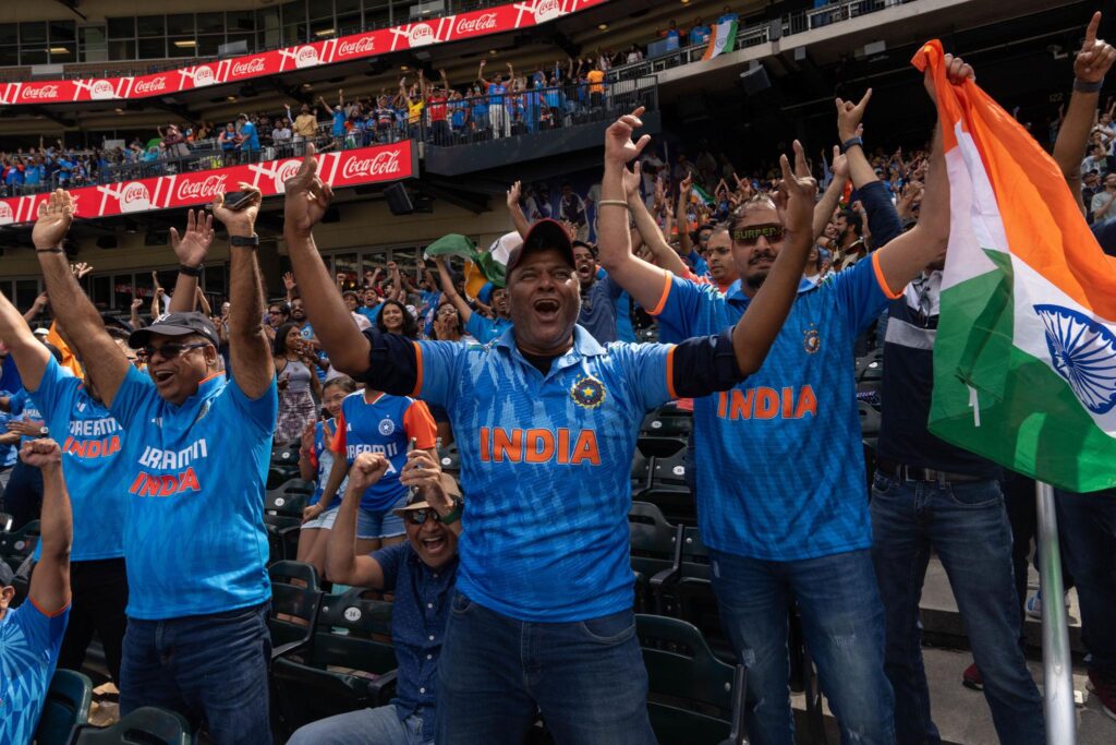 India vs Pakistan cricket rivalry match Indian fans celebrating in stadium with national flag