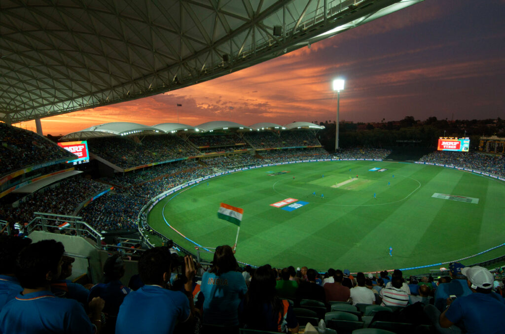 Packed Adelaide Oval stadium during intense India vs Pakistan cricket rivalry match at sunset.
