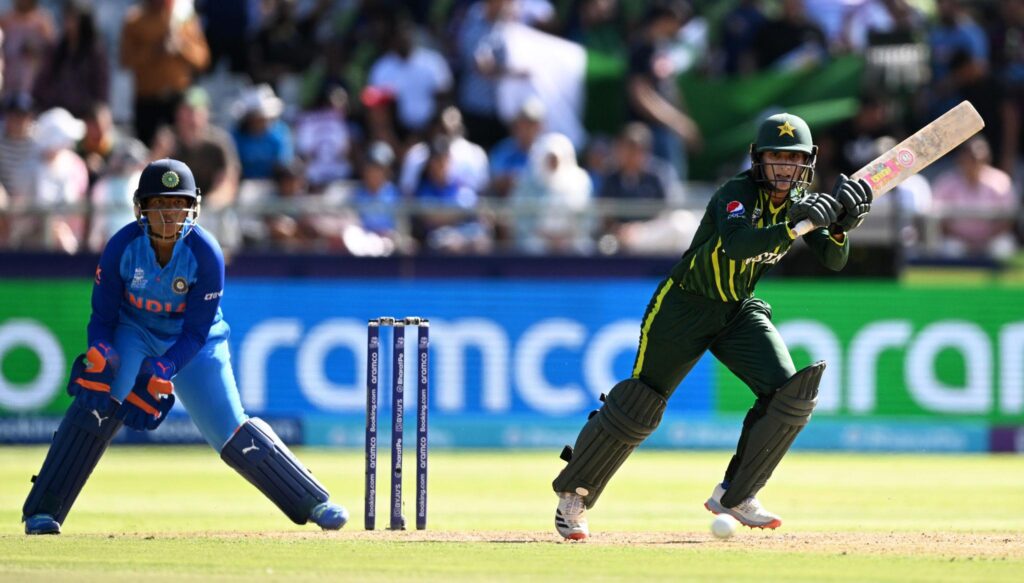 India vs Pakistan cricket rivalry match action as Pakistan batter plays a shot while Indian wicketkeeper watches behind the stumps